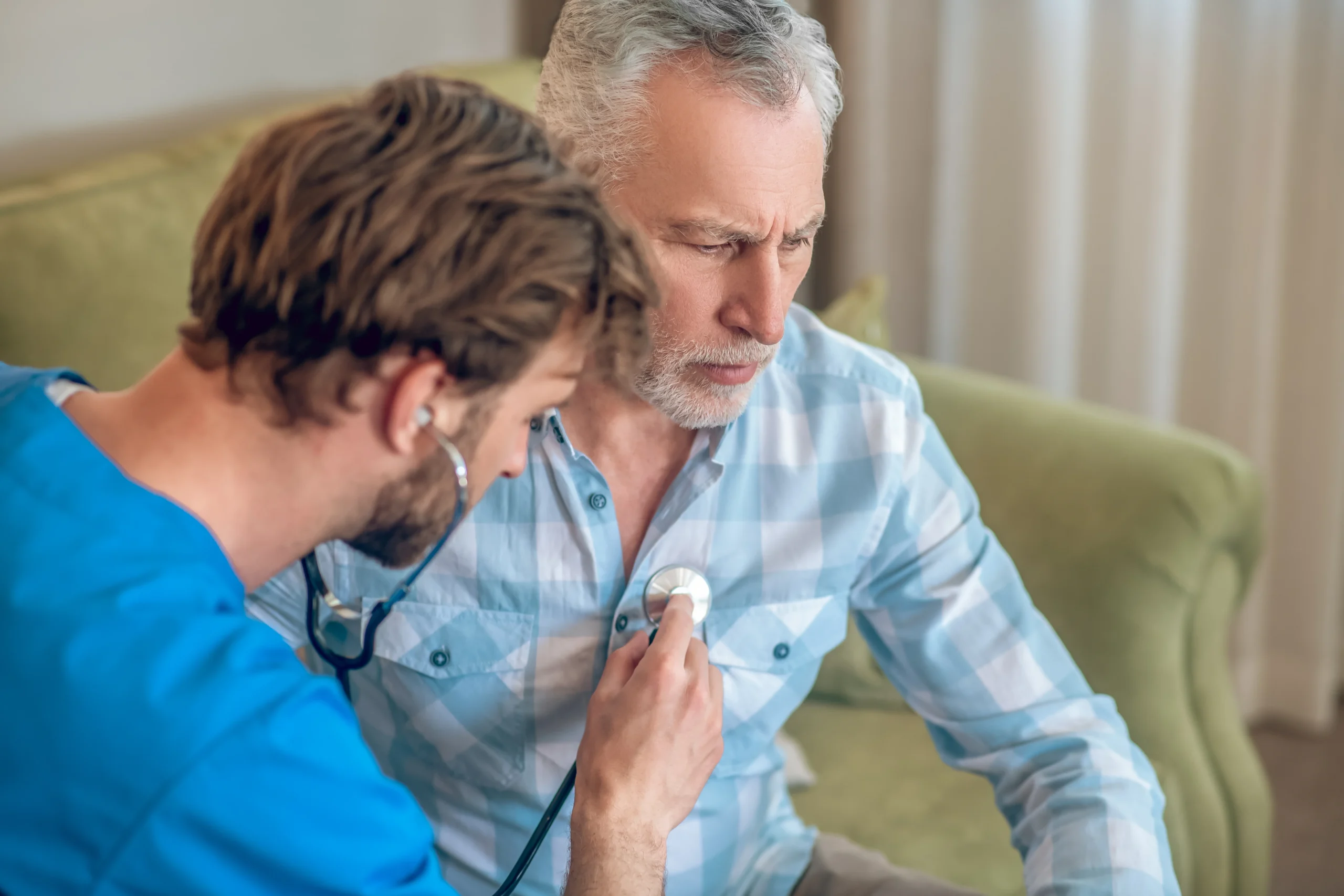 a cardiologist checks a patient's heart